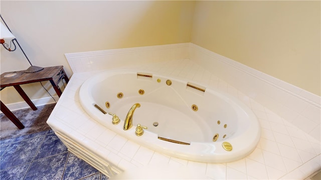 bathroom with tile patterned flooring and tiled tub