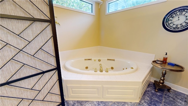 bathroom featuring tile patterned flooring and tiled bath