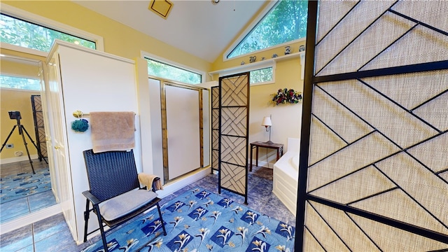 interior space featuring tile patterned flooring, high vaulted ceiling, and a wealth of natural light