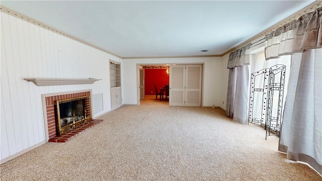 unfurnished living room with built in shelves, carpet floors, and a brick fireplace