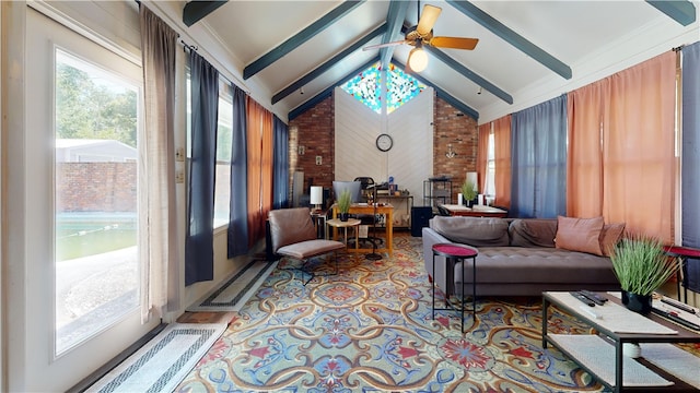 interior space featuring lofted ceiling with beams, ceiling fan, and ornamental molding