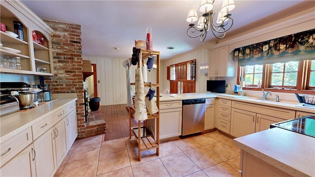 kitchen with stainless steel dishwasher, kitchen peninsula, a chandelier, pendant lighting, and light tile patterned floors