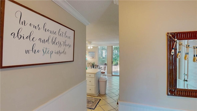 corridor featuring crown molding and light tile patterned flooring