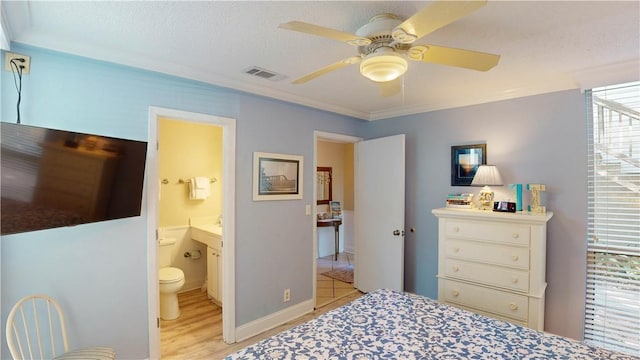 bedroom featuring a textured ceiling, light wood-type flooring, ensuite bathroom, and ceiling fan