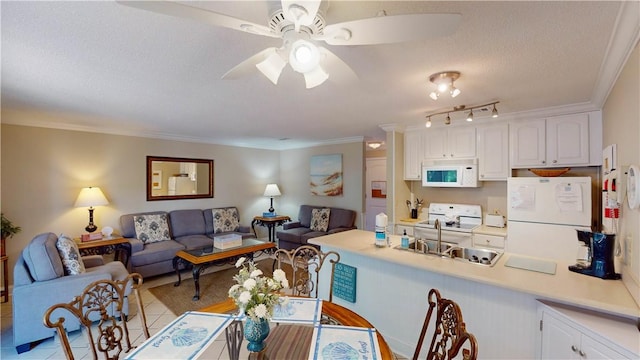 interior space with a textured ceiling, ceiling fan, crown molding, sink, and light tile patterned floors