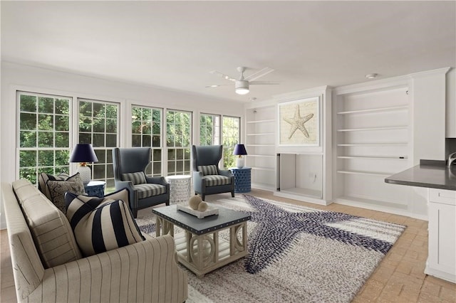 104 Augusta, Saint Simons Island, GA 31522 - living area with a healthy amount of sunlight, built in features, ceiling fan, and brick floor