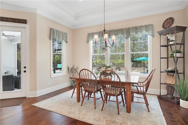 dining room with crown molding, baseboards, a chandelier, and wood finished floors