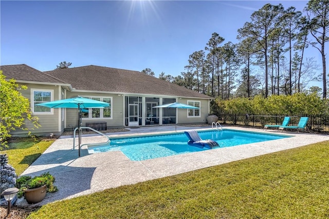 view of swimming pool featuring a yard, a fenced in pool, a patio area, and fence