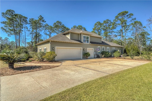 traditional home with an attached garage and concrete driveway