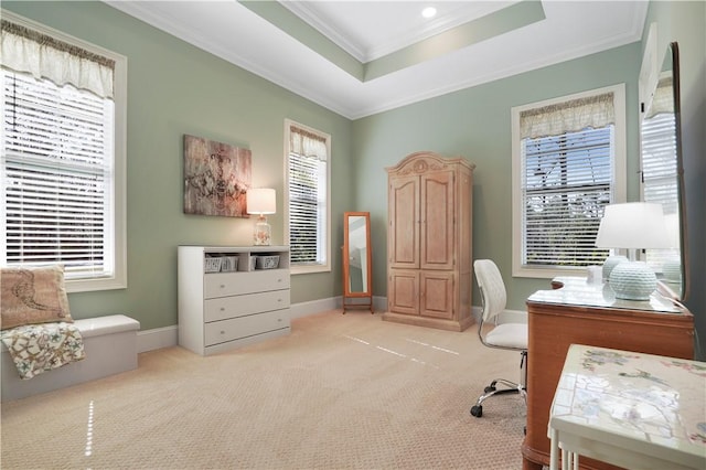 office space with baseboards, a tray ceiling, light colored carpet, and ornamental molding