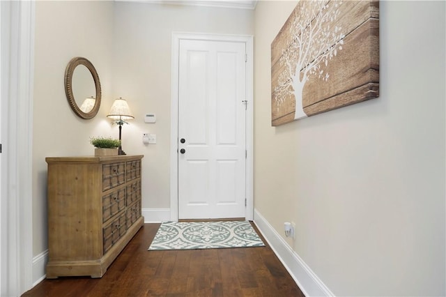 doorway to outside with wood finished floors and baseboards