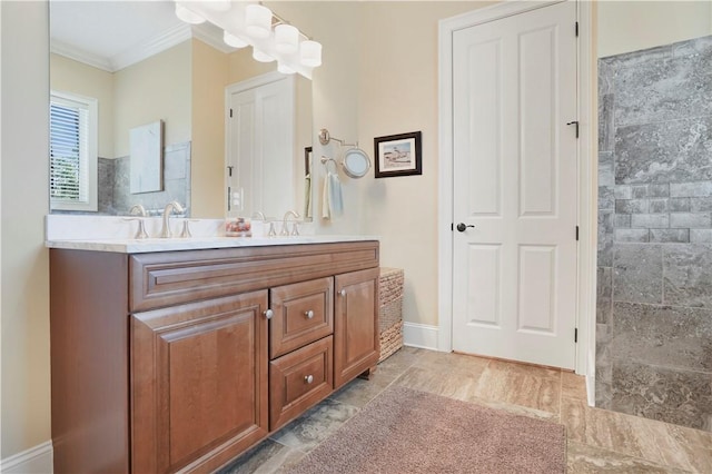 bathroom featuring ornamental molding, a sink, baseboards, and double vanity