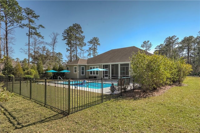 view of pool featuring a fenced in pool, fence, a lawn, and a patio