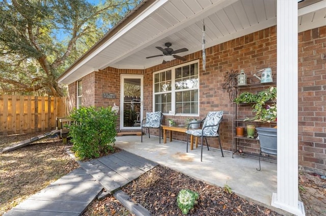 view of patio / terrace with a ceiling fan and fence