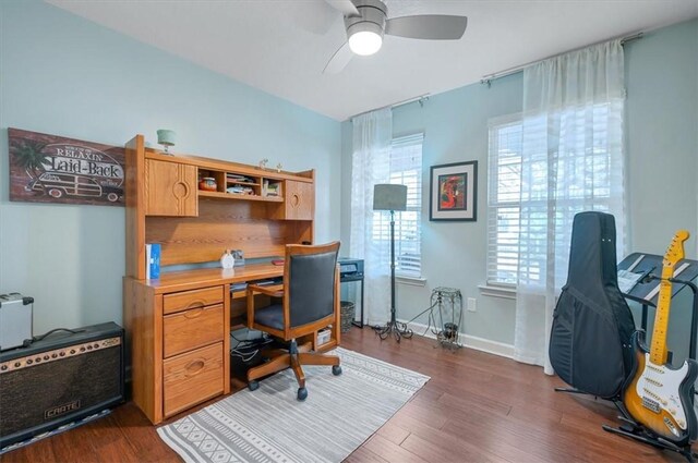 home office featuring dark wood-style floors, baseboards, and a ceiling fan