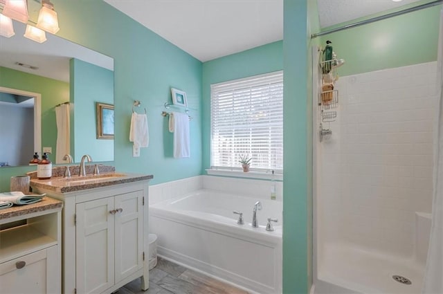 full bath featuring visible vents, a garden tub, vanity, and a shower stall