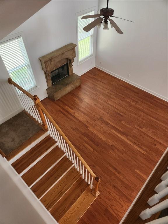 115 Simonton Way, Saint Simons Island, GA 31522 - unfurnished living room featuring hardwood / wood-style floors, ceiling fan, and a premium fireplace