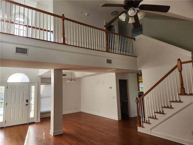 115 Simonton Way, Saint Simons Island, GA 31522 - entrance foyer featuring ceiling fan with notable chandelier, wood-type flooring, and a towering ceiling
