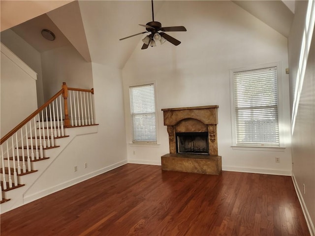 unfurnished living room with dark hardwood / wood-style floors, ceiling fan, and high vaulted ceiling