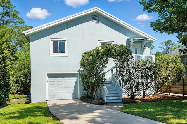 310 Peachtree St, Saint Simons Island, GA 31522 - view of front of house featuring stairway, an attached garage, stucco siding, a front yard, and concrete driveway