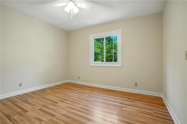 310 Peachtree St, Saint Simons Island, GA 31522 - empty room with light wood-style floors and ceiling fan