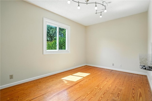 310 Peachtree St, Saint Simons Island, GA 31522 - spare room with baseboards and light wood-style floors