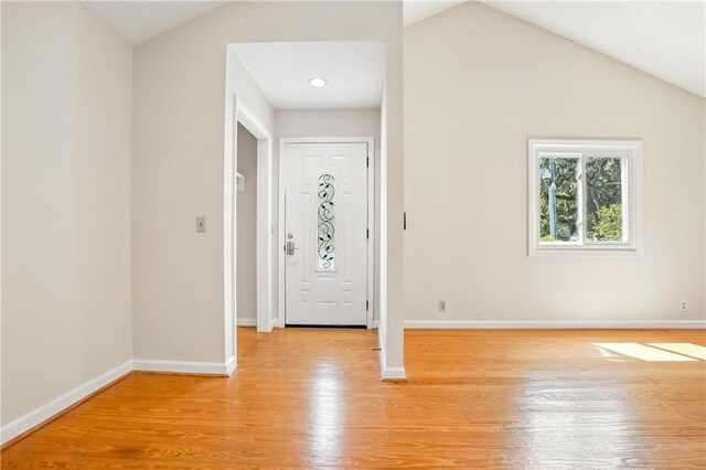 310 Peachtree St, Saint Simons Island, GA 31522 - entryway with light wood finished floors and vaulted ceiling