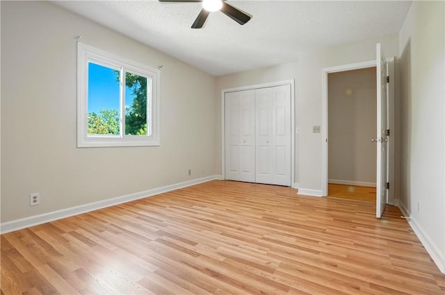 310 Peachtree St, Saint Simons Island, GA 31522 - unfurnished bedroom with light wood-style flooring, a closet, ceiling fan, and a textured ceiling