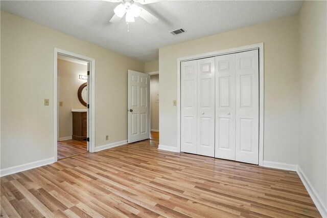 310 Peachtree St, Saint Simons Island, GA 31522 - unfurnished bedroom featuring light wood finished floors, a closet, ensuite bathroom, and a ceiling fan