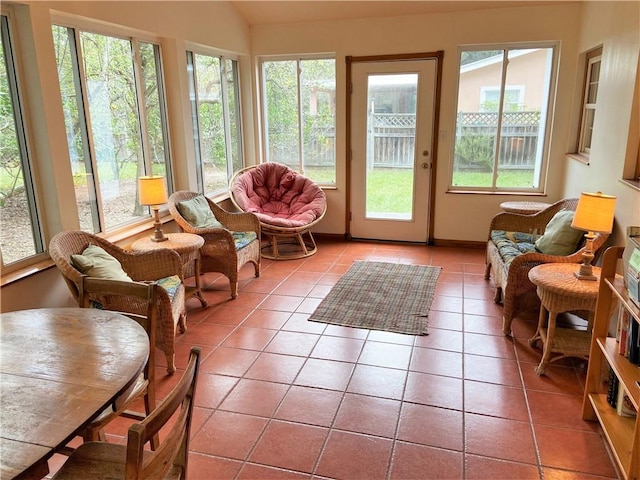 sunroom / solarium featuring vaulted ceiling