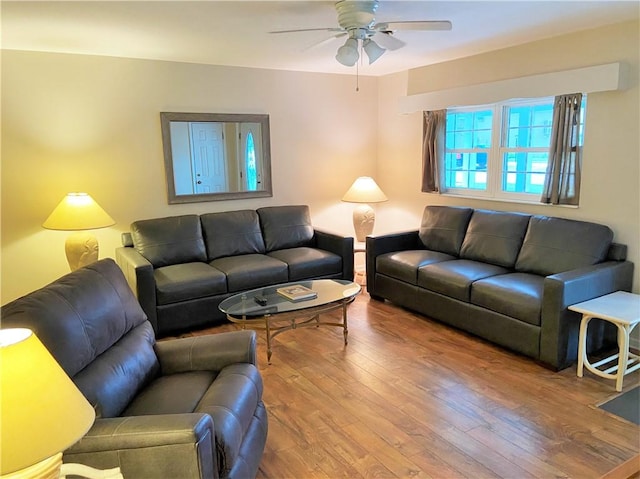 living area featuring ceiling fan and wood finished floors