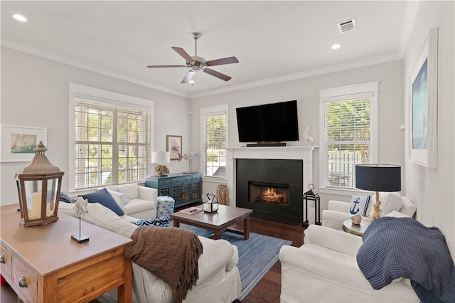 1073 Demere Rd, Saint Simons Island, GA 31522 - living area with dark wood-type flooring, crown molding, a ceiling fan, a warm lit fireplace, and recessed lighting