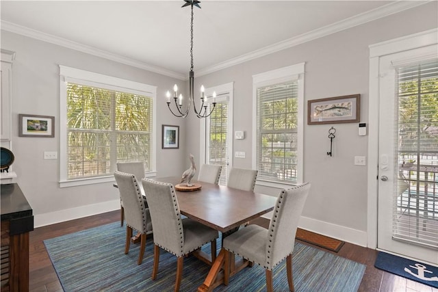 1073 Demere Rd, Saint Simons Island, GA 31522 - dining room with a chandelier, dark wood finished floors, crown molding, baseboards, and healthy amount of natural light