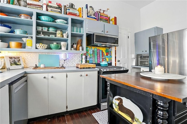 604 Union St, Brunswick, GA 31520 - kitchen with appliances with stainless steel finishes, open shelves, dark wood-type flooring, and light countertops