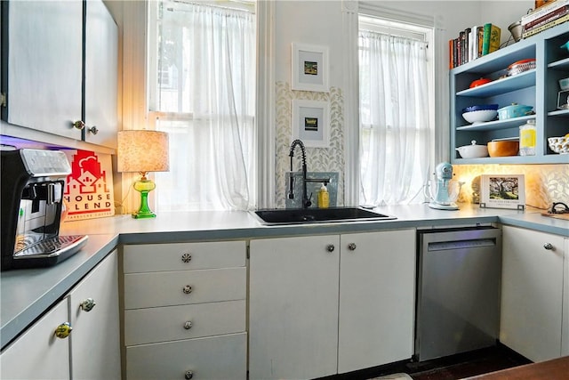 604 Union St, Brunswick, GA 31520 - kitchen featuring stainless steel dishwasher, white cabinetry, light countertops, and open shelves
