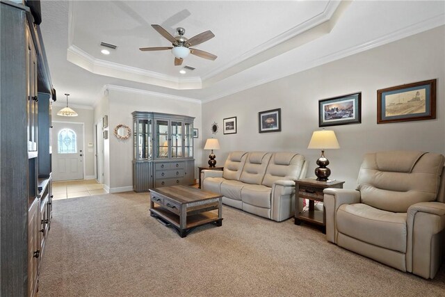 199 Austin Ryan Dr, Kingsland, GA 31548 - living room featuring light carpet, a ceiling fan, a tray ceiling, and ornamental molding
