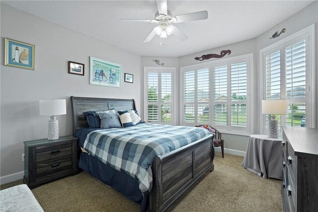 199 Austin Ryan Dr, Kingsland, GA 31548 - bedroom featuring light colored carpet, multiple windows, baseboards, and a ceiling fan