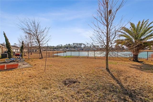 view of yard featuring a water view and central air condition unit