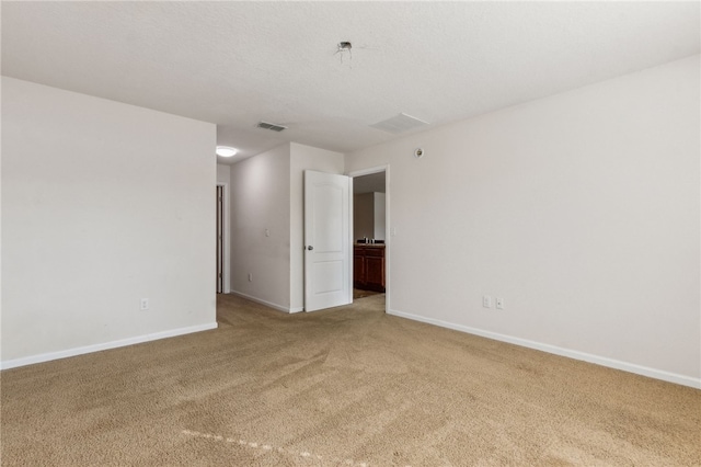 unfurnished room featuring carpet floors and a textured ceiling