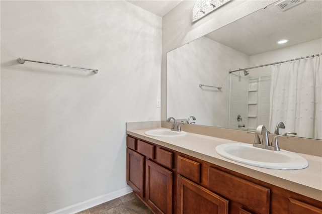 bathroom featuring vanity, shower / bathtub combination with curtain, and tile patterned flooring