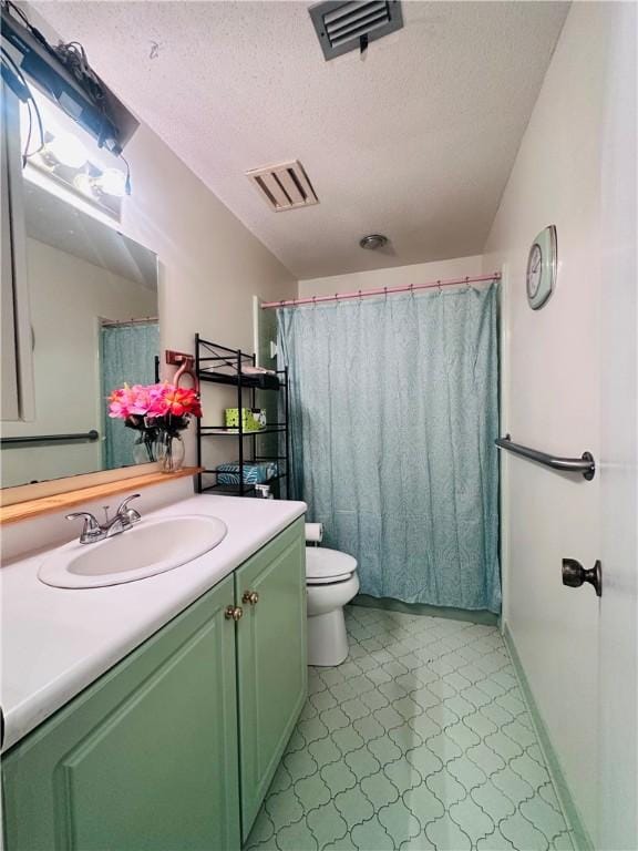 bathroom with tile patterned floors, visible vents, toilet, and a textured ceiling