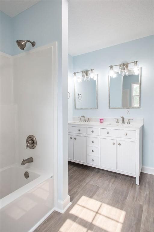 3 Dixon Ln, Blackshear, GA 31516 - full bathroom with wood finished floors, bathtub / shower combination, double vanity, and baseboards
