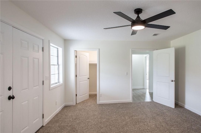 3 Dixon Ln, Blackshear, GA 31516 - unfurnished bedroom featuring carpet floors, baseboards, a walk in closet, and ceiling fan