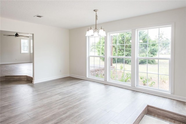 3 Dixon Ln, Blackshear, GA 31516 - unfurnished dining area featuring a chandelier, wood finished floors, baseboards, and a ceiling fan