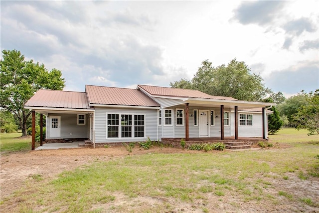 3 Dixon Ln, Blackshear, GA 31516 - view of front of home featuring a carport, a porch, a front lawn, and metal roof