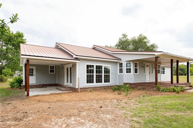 3 Dixon Ln, Blackshear, GA 31516 - back of property with metal roof, covered porch, and entry steps