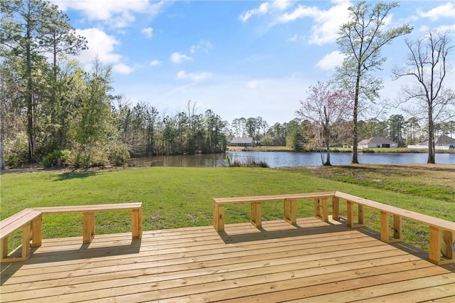 deck with a yard and a water view