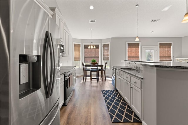 kitchen with visible vents, white cabinets, appliances with stainless steel finishes, and dark wood-type flooring