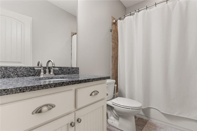 bathroom with vanity, toilet, and shower / bath combo