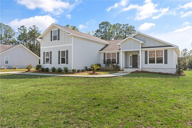 view of front of property featuring roof with shingles, board and batten siding, and a front yard